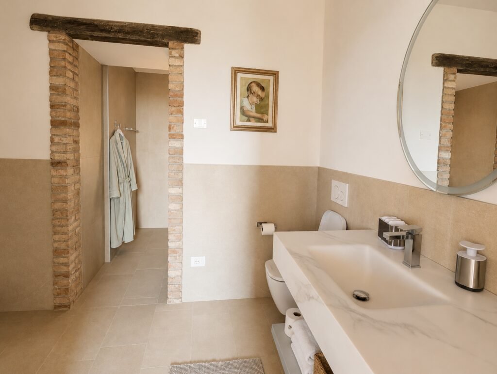 Ensuite bathroom with marble vanity and backlit mirror