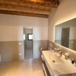 Ensuite bathroom with marble vanity and backlit mirror